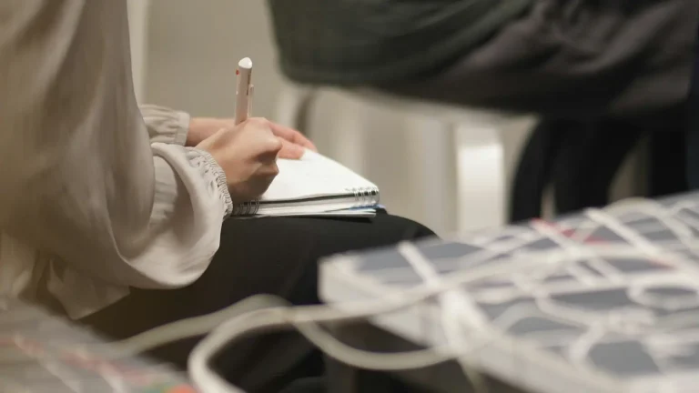 Person using a notebook during a business meeting