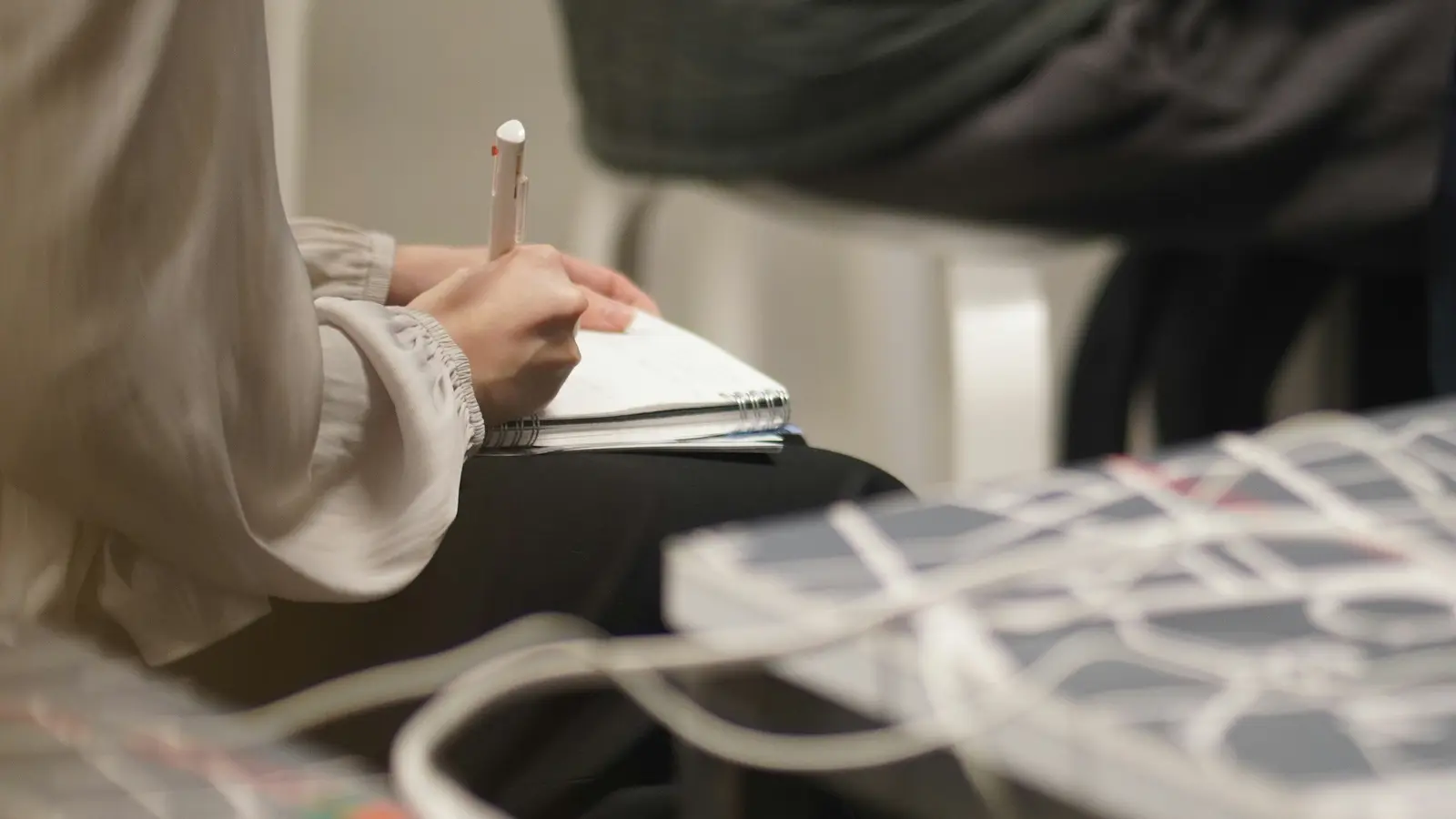 Person using a notebook during a business meeting