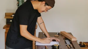 Technician completing a work order form on a clipboard in a workshop